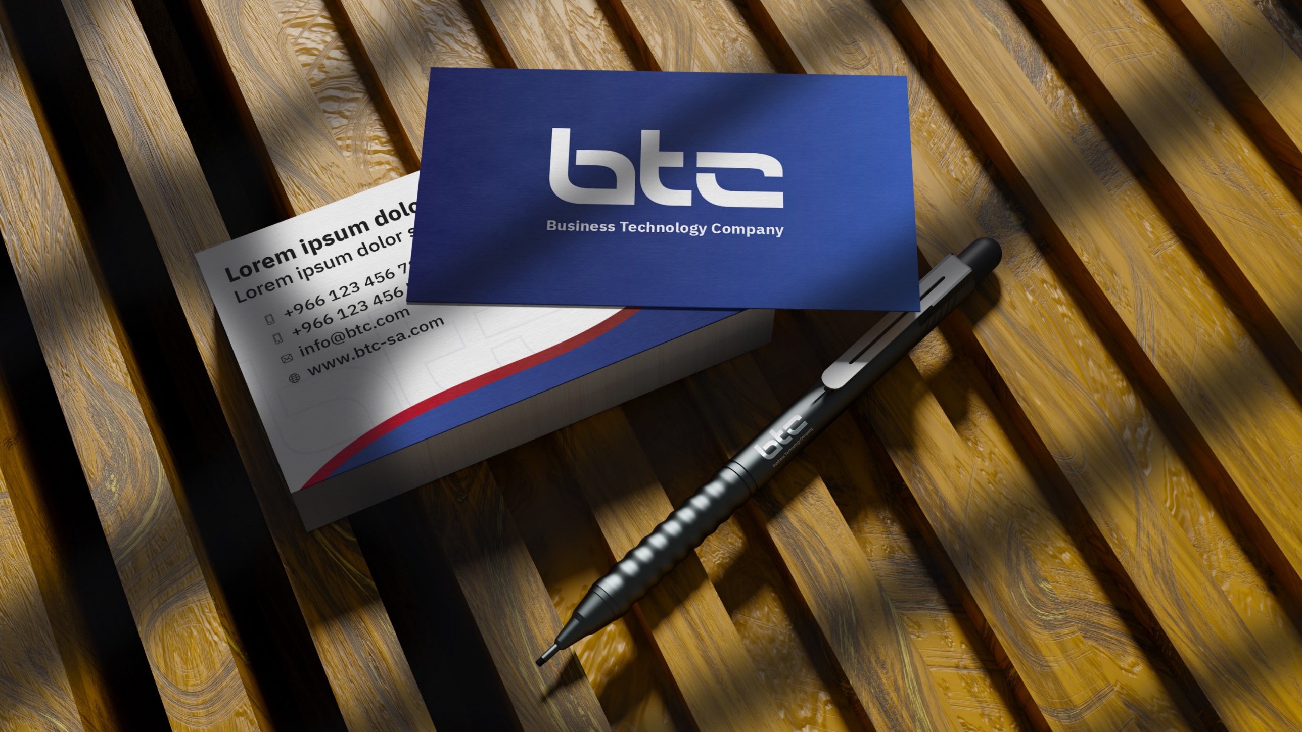 BTC business cards and pen on a desk